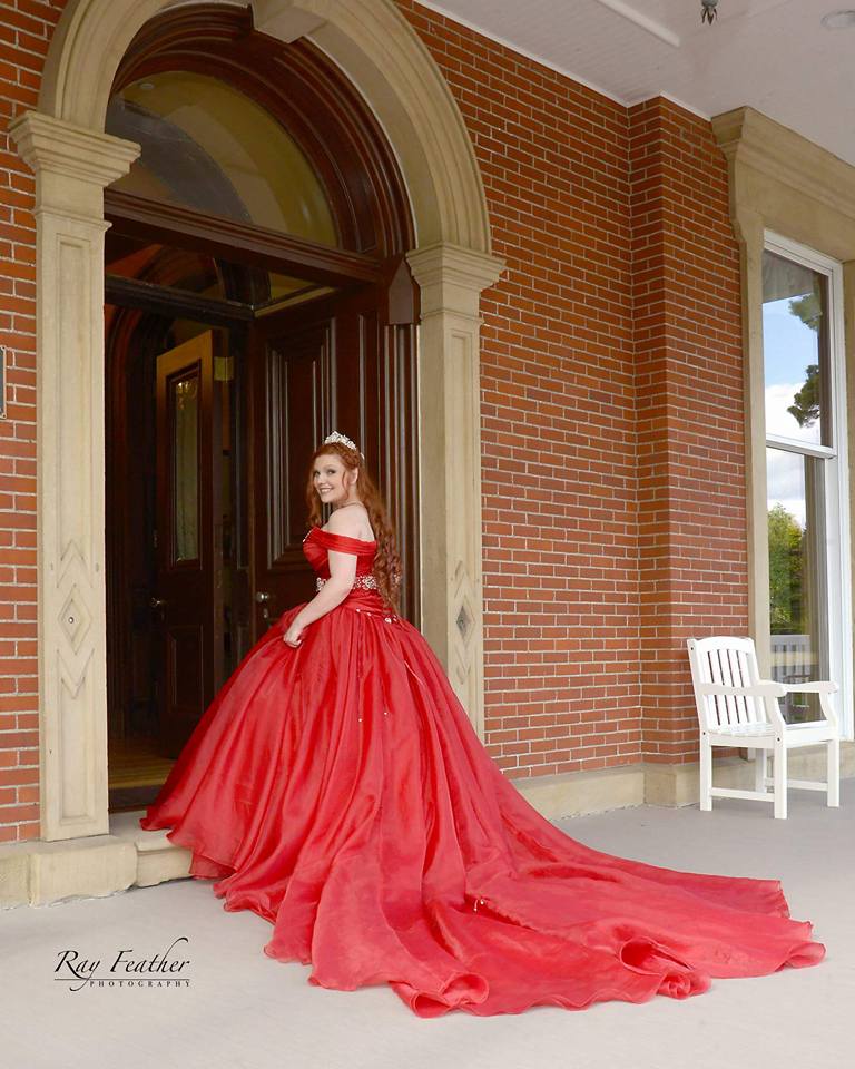 Bride in Red dress entering mansion for wedding