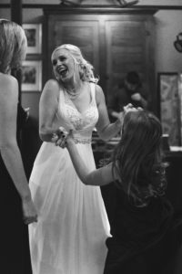 bride and flowergirl dancing