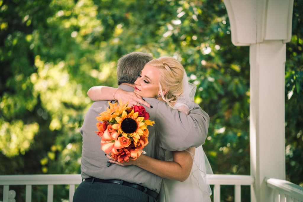 Bride and dad hugging