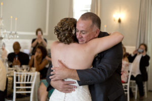 bride and dad hugging cleveland wedding planner