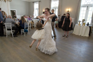 bride and flower girl dancing