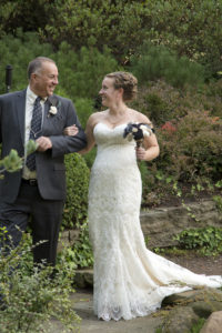 bride and dad smiling at each other